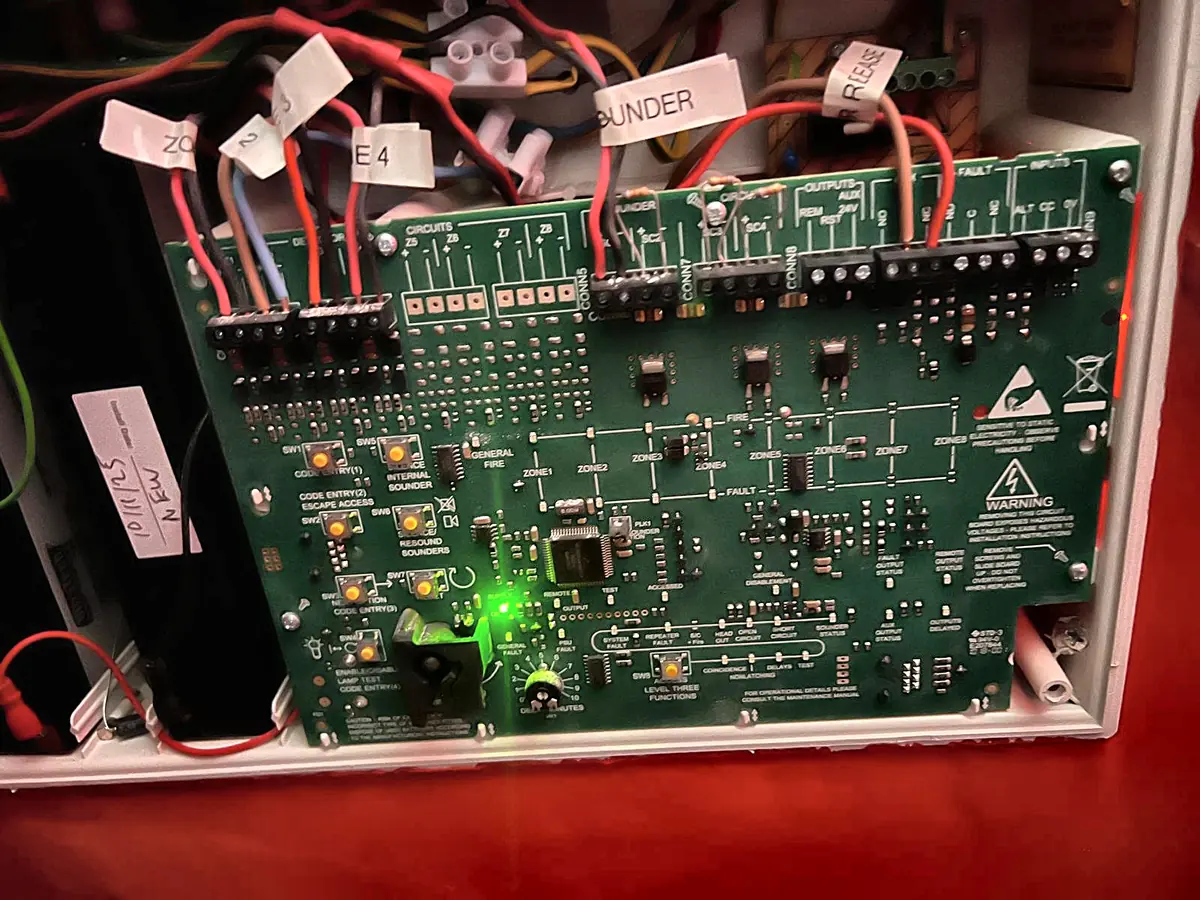 Inside the C-TEC panel: the main board, its zone and sounder terminals labelled