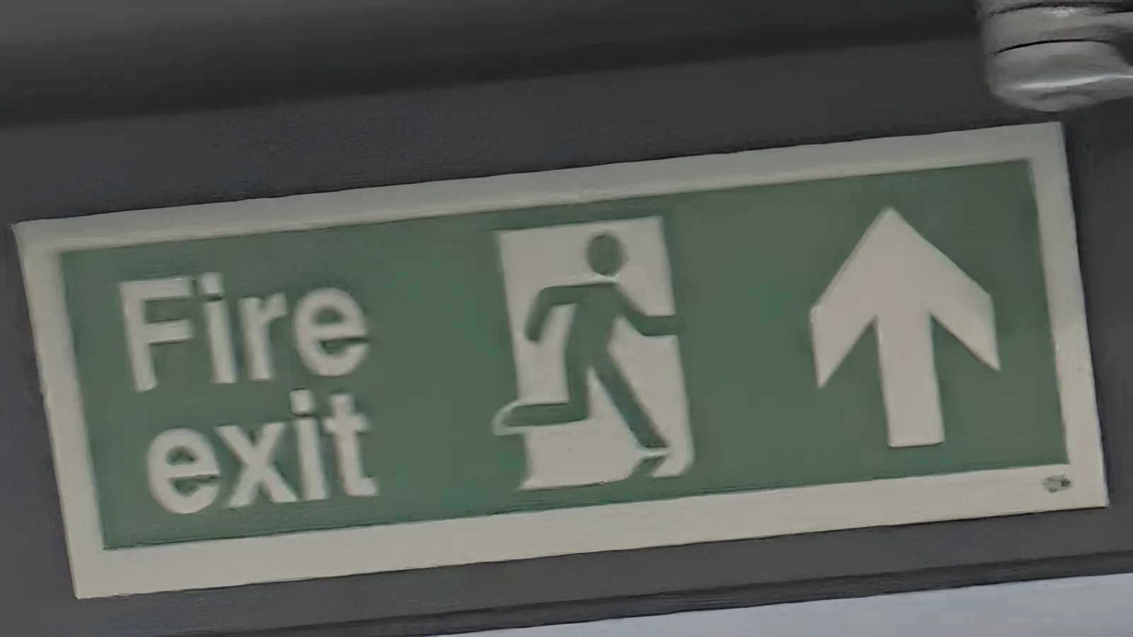 Emergency lighting repairs in London: a fire exit sign above an escape route