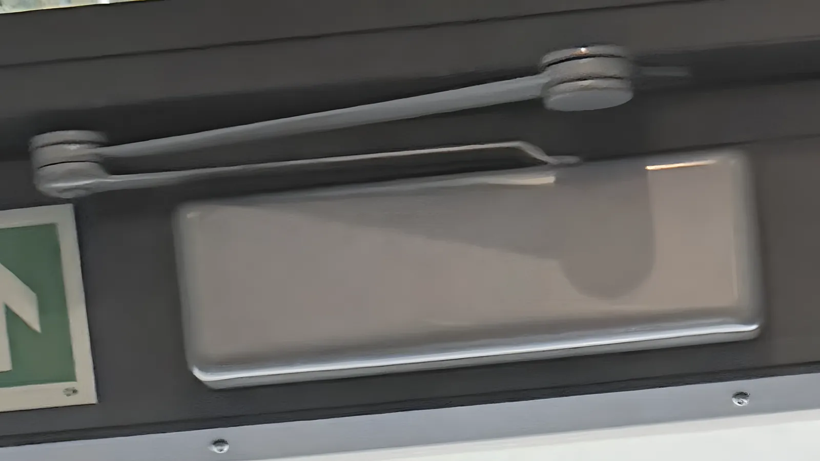 Fire door repairs in London: the overhead closer on a fire exit door